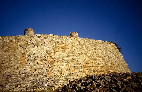 10007780. ZIMBABWE Forts Great Zimbabwe Ruins. Towering stone wall of the abandoned city
