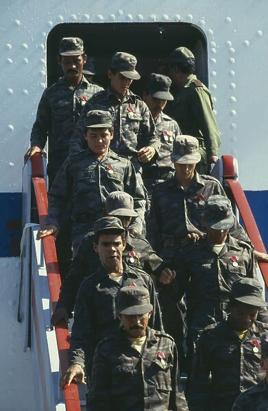 10068392. CUBA Military Soldiers descending steps of a plane after returning from Angola