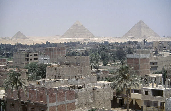 20039837. EGYPT Cairo City suburbs encroaching on the Pyramids at Giza