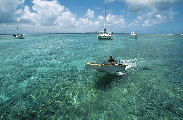 20049122. MAURITIUS Isle Gabriel Man riding speedboat on turquoise sea