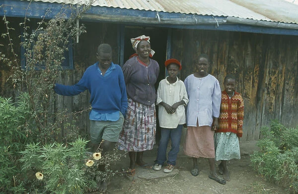 20053301. KENYA Families Portrait of rural family standing outside house near Bomet