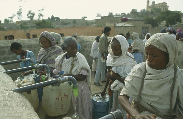 20070825. ERITREA Seraye Women filling containers at water point
