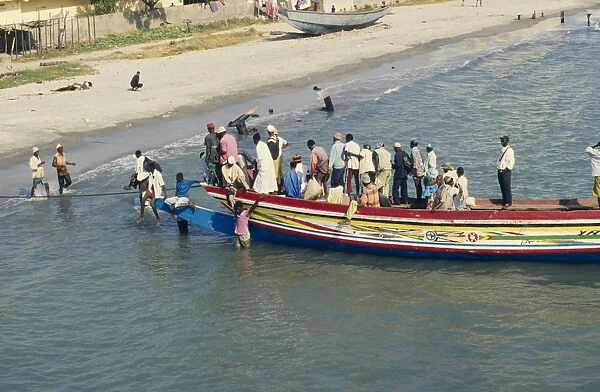 20075223. GAMBIA Banjul Busy local ferry arriving into shore