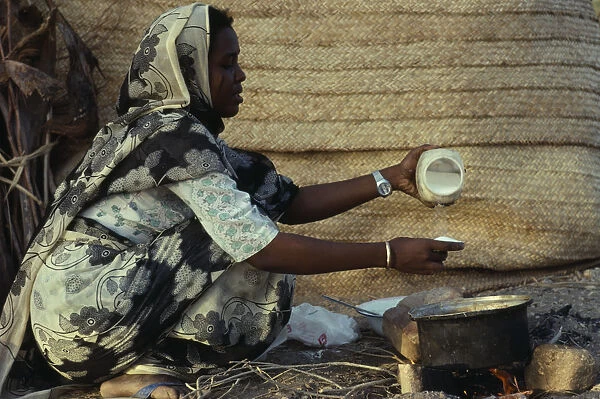 20075419. SUDAN Red Sea Hills Province Beja nomad woman cooking mededa gruel made