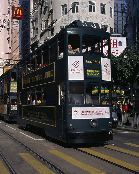 CHINA, Hong Kong, Transport Hong kong Island tram on city street with high rise
