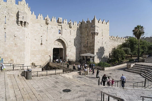 People pass through the Damascus gate in the walls of the Old City of Jerusalem