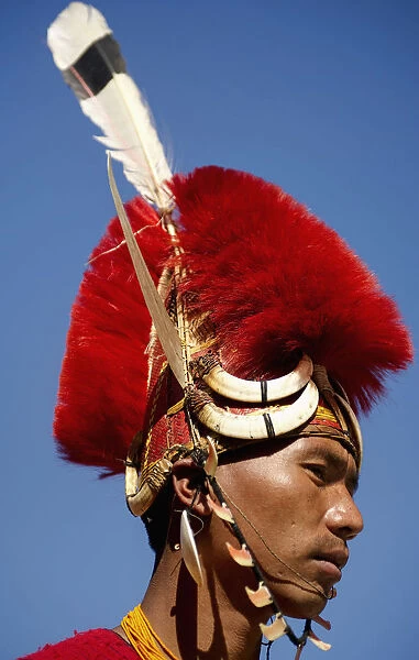 PORTRAIT OF A TRIBAL FROM A NAGA WARRIOR TRIBE WEARING TRADITIONAL COSTUME AND JEWELRY