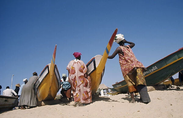 SENEGAL, Soumbedioune Women wearing brightly coloured traditionally patterned clothing