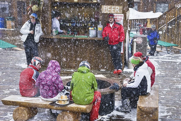 Skiers at outdoor bar in the snow