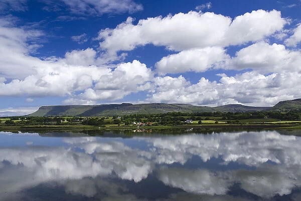 Sligo Bay and Ben Bulben from outskirts of the town. Blue sky and white cloudscape reflected in water