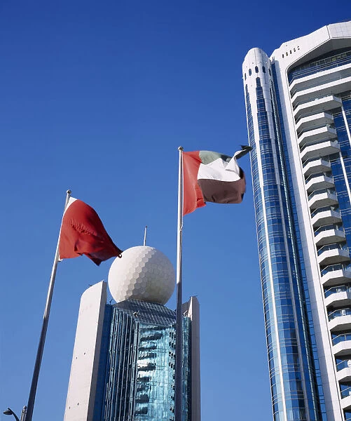 UAE, Dubai, Deira Etisalat Building on Dubai Creek with flag poles in foreground