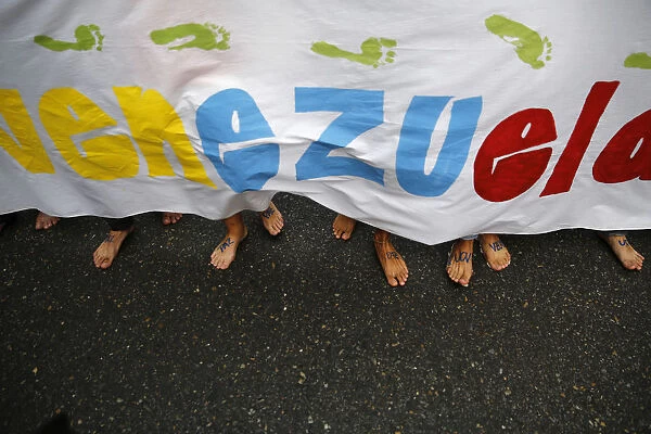 Anti-government protesters march barefooted during a protest in Caracas