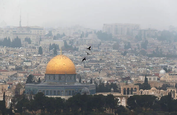 Birds fly on a foggy day near the Dome of the Rock, located in Jerusalems Old City