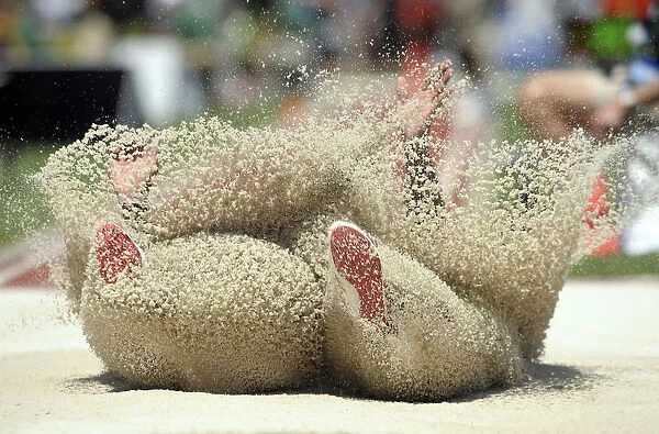 Bryce Lamb lands in the pit during the mens long jump at the U. S