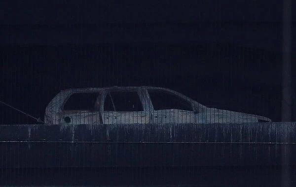 The burned out shell of a car is seen following a serious blaze which destroyed hundreds