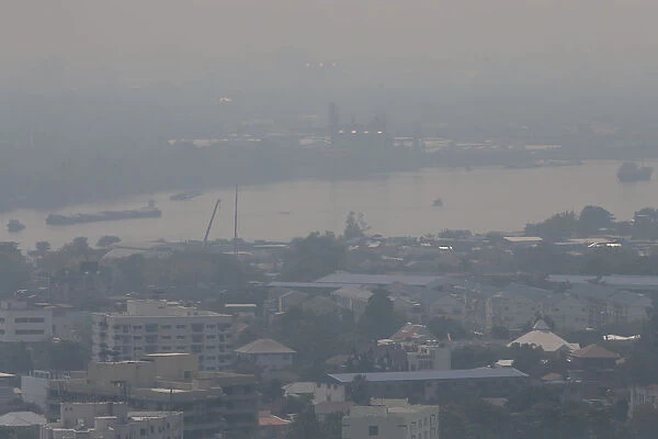 The Chao Phraya River is seen through air pollution in Bangkok