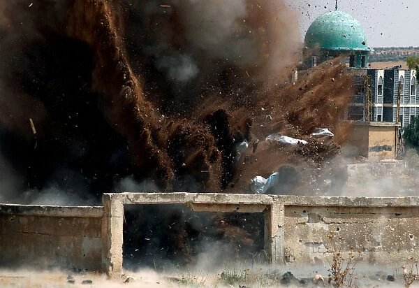 Civil defense members safely detonate cluster bombs in the rebel-held area in Deraa