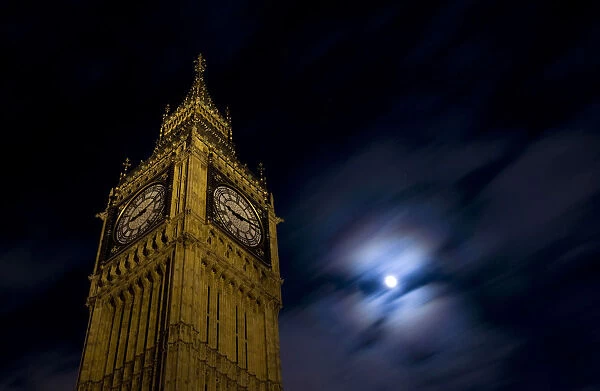 The clock tower at the Houses of Parliament is pictured beneath the moon in London