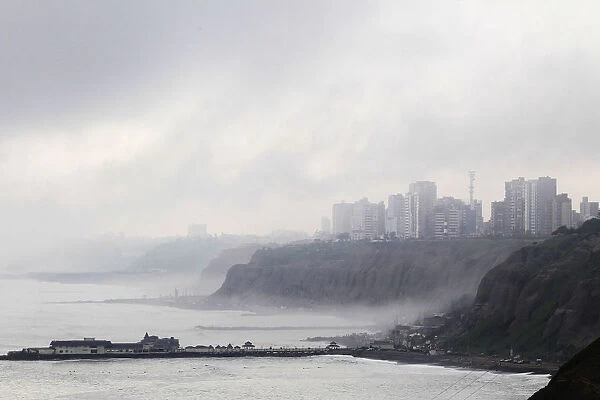 A coastal neighborhood in the district of Miraflores is covered by fog in Lima