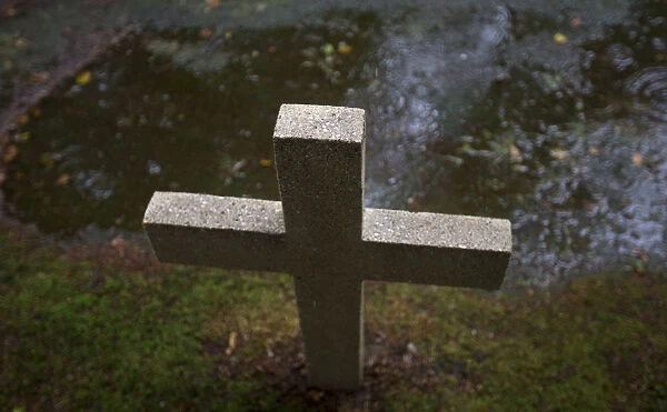 A cross mark the grave of a soldier in one of the WW1 military cemeteries in the village