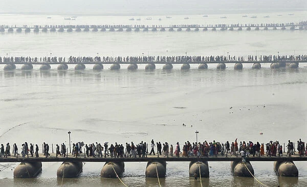 Devotees make their way across pontoon bridges spanning the Sangam during Magh Mela