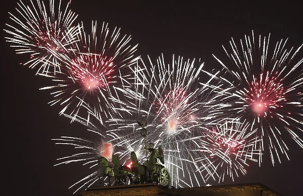 Fireworks explode next to the Quadriga sculpture atop the Brandenburg gate during New