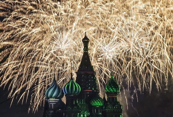 Fireworks explode above St. Basils cathedral during Spasskaya Tower international