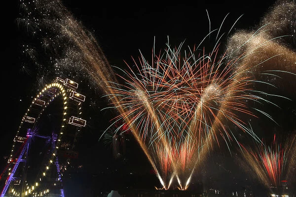 Fireworks explode beside Viennas Giant Ferris Wheel at Prater park during New Year