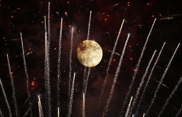 Fireworks shoot past moon as ceremony presided by Pope Benedict XVI came to an end