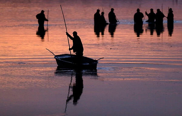 Fishermen set out to begin the traditional carp haul near the town of Trebon