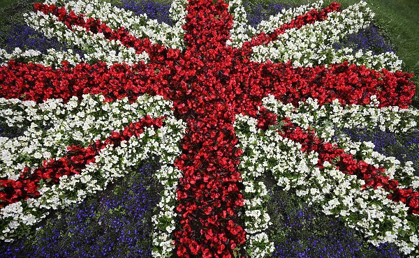 A floral display in the design of a British Union Jack flag is seen by the side of a road