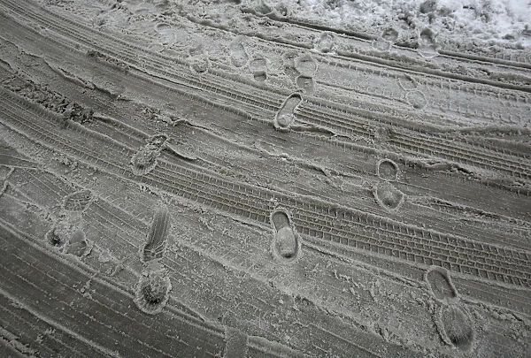 Footprints are left in the slush on a street during a snow storm in downtown New York