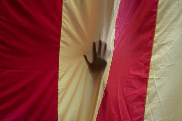 A hand is seen through a giant Estelada (Catalan separatist flag