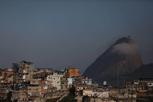 Houses at the Santo Amaro slum are seen with the Sugar Loaf mountain in the background