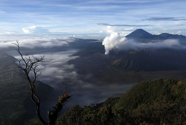 Indonesias Mount Bromo volcano spew smoke next to Mount Semeru volcano as seen