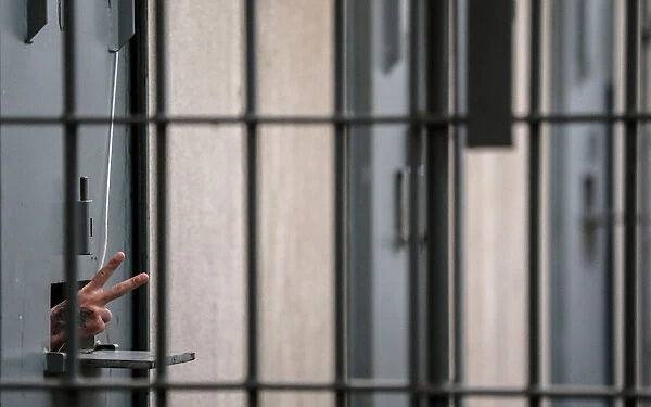An inmate gestures at the state penitentiary in Canoas