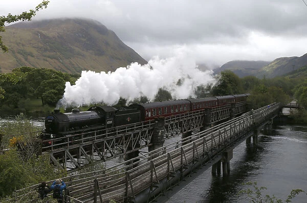 The Jacobite steam train crosses the river Lochy as it departs Fort William, Scotland