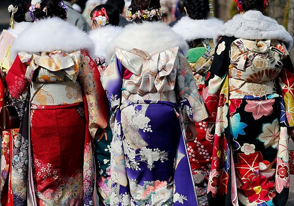 Japanese women wearing kimonos attend their Coming of Age Day celebration ceremony at an