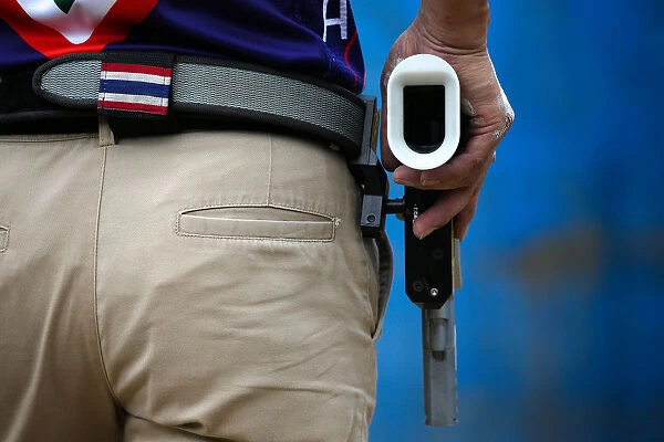 A man prepares to shoot during a practice session at a shooting range in Bangkok