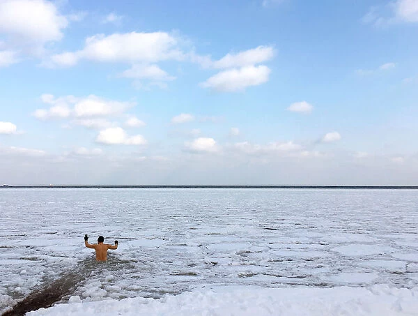 A man takes a bath in partly frozen Baltic sea in Gdynia