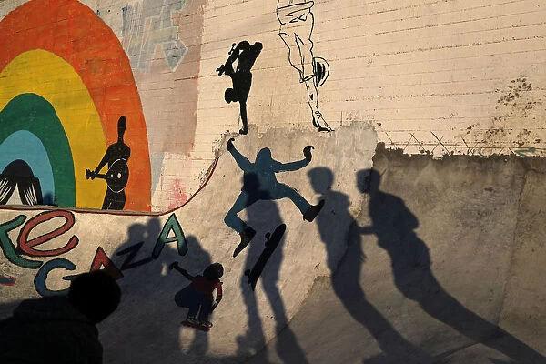 Members of Gaza Skating Team cast shadows as they practice their rollerblading