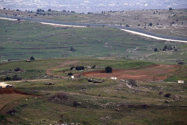 Military vehicles can be seen positioned on the Israeli side of the border with Syria
