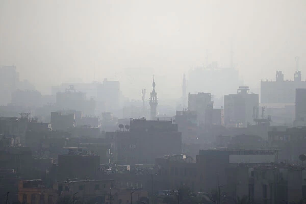 A minaret is seen through early morning haze on the skyline of Cairo
