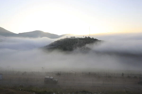 Morning mist covers the Israeli-Syrian border near Majdal Shams in the Golan Heights