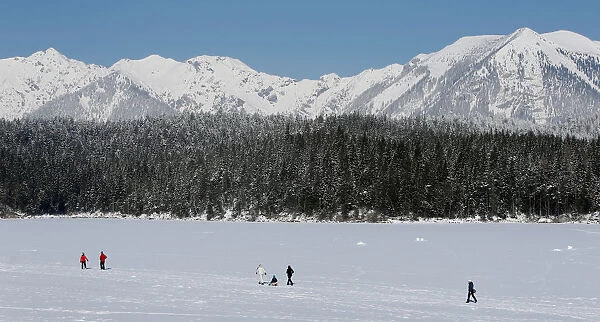 People walk over the frozen up lake Eibsee in Grainau near Garmisch-Partenkirchen
