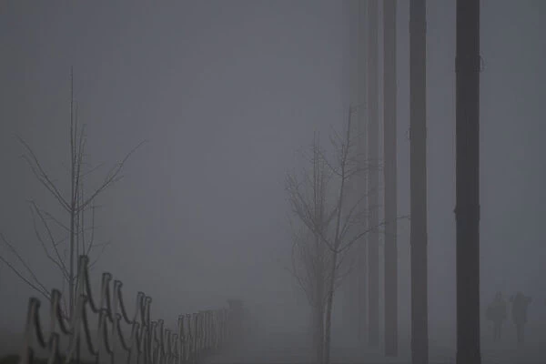 People walk through heavy fog in Belfast