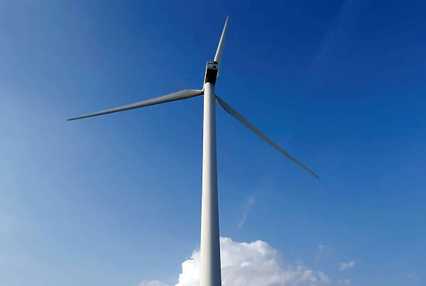A power-generating wind turbine is seen near the city of Mouchamps