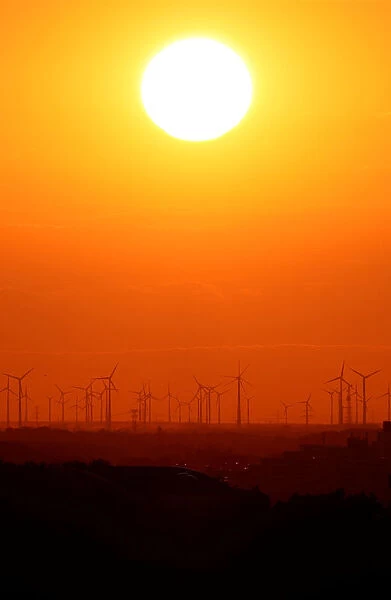 Power-generating windmill turbines are pictured during sunset from the Drachenberg hill