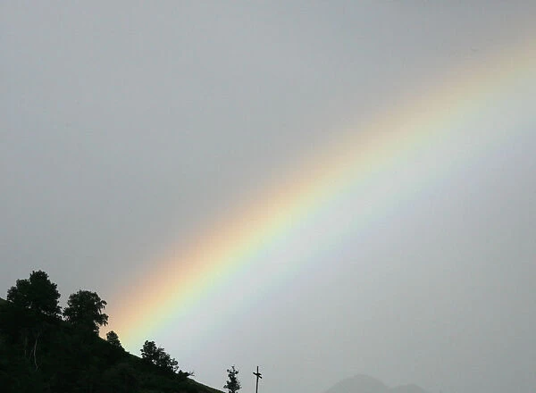 A rainbow is pictured during a rain shower near Bettmeralp