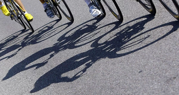 The shadows of riders are cast on the road during the third stage of the 96th Tour